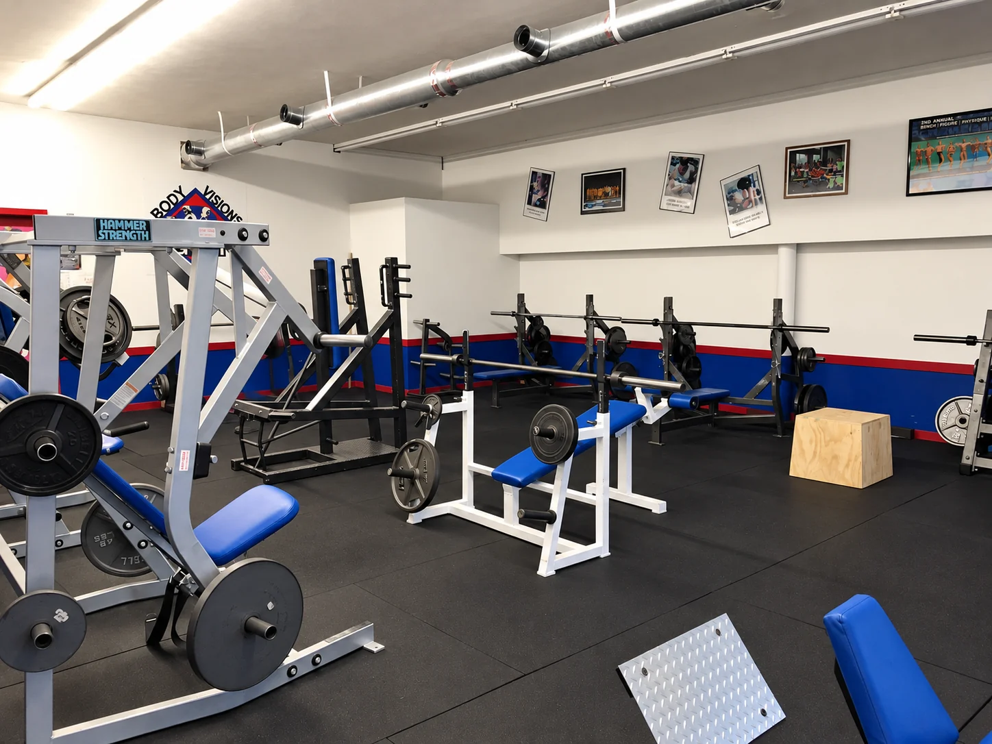 Free weights and blue weight benches at Body Visions Gym
